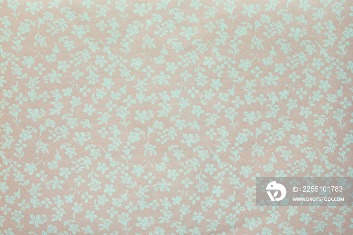 A piece of fabric with the image of small flowers in pastel colors