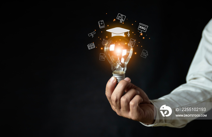 a man holding a light bulb showing his graduation cap internet education course A study of knowledge to creativity and problem-solving concepts for the e-learning graduate certificate course.