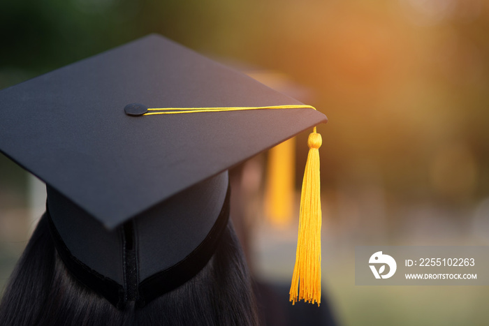 Back portrait of graduated wearing a black hat.