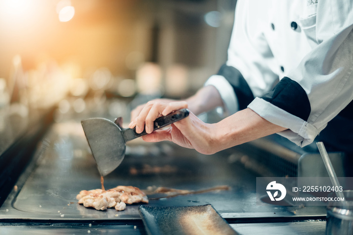 Hand of man take cooking of meat with vegetable grill, Chef cooking wagyu beef in Japanese teppanyaki restaurant