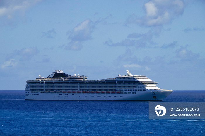 Big modern MSC Cruises cruiseship or cruise ship liner Divina anchoring out of Port of Miami, Florida skyline and skyscrapers in background waiting for passengers for Caribbean cruising holiday