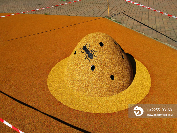 The figure of an anthill on the playground of soft rubber crumb in Prague