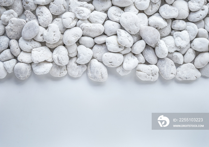 White pebbles stone on white background with copy space