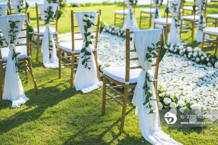 Chair decorated with flowers in Wedding ceremony.