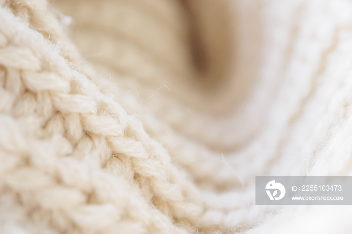 closeup beige knitted woolen fabric texture background