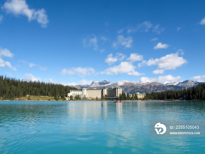 The Fairmont Chateau Lake Louise. Fairmont hotel on the eastern shore of Lake Louise. Tourist can enjoy the emerald lake, scenic view and mountain and canoe boat