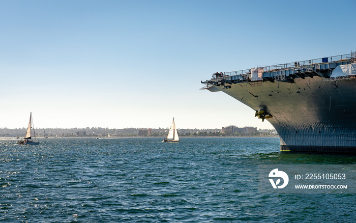 View of the San Diego bay with sailing boats and the prow of the UUS Midway.