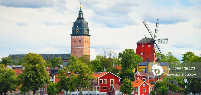 Panoramic cityscape from a sailing boat. Cathedral, traditional houses, windmill. Strängnäs, Mälaren lake, Sweden. Travel destinations, landmarks, sightseeing, cruise, culture