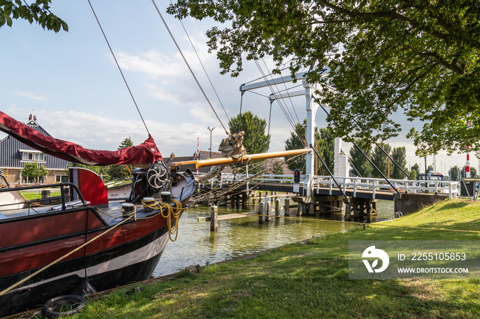 A white drawbridge called Koebrug in the center of the Dutch picturesque fishing village of Stavoren.