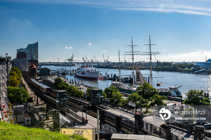 Hamburg harbor, Germany: Beautiful panoramic view of the harbor with Elbe on a sunny day with blue sky in summer, St. Pauli district, train station Landungsbruecken