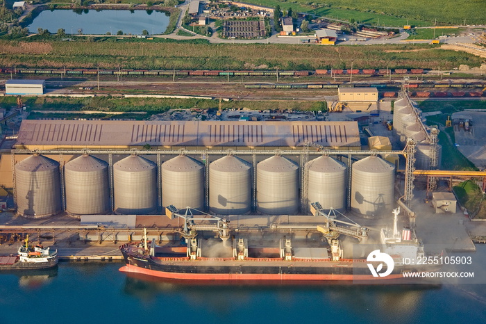 loading a ship with grain in the seaport.aerial conveyour grain industry loading port sea shiploader silo storehouse transport transhipment trade berth handling