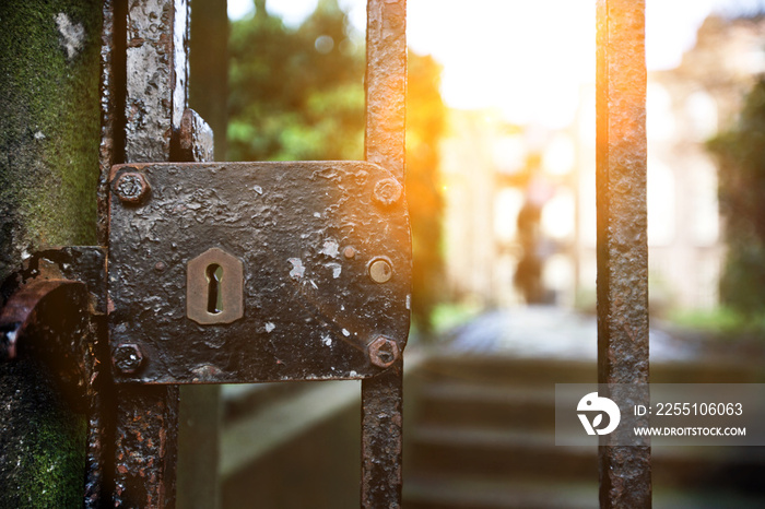 Vintage lock on iron gate with sunshine