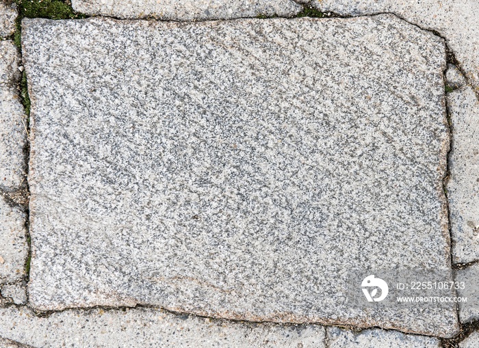 texture of the stone. Rectangular stone plates of gray granite color with mica elements.