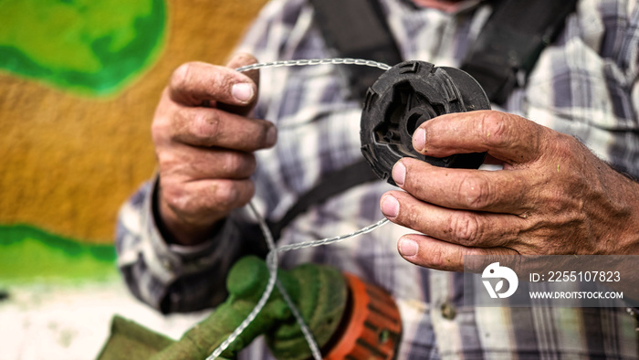 A man is fixing his lawn mower