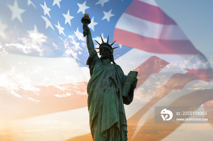 Double exposure with statue of liberty and United States flag blowing in the wind.