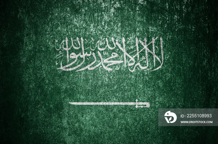 Closeup of grunge Saudi flag. Dirty Saudi Arabia flag on a metal surface