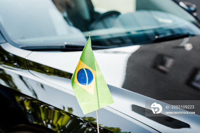 selective focus of brazilian flag on modern car