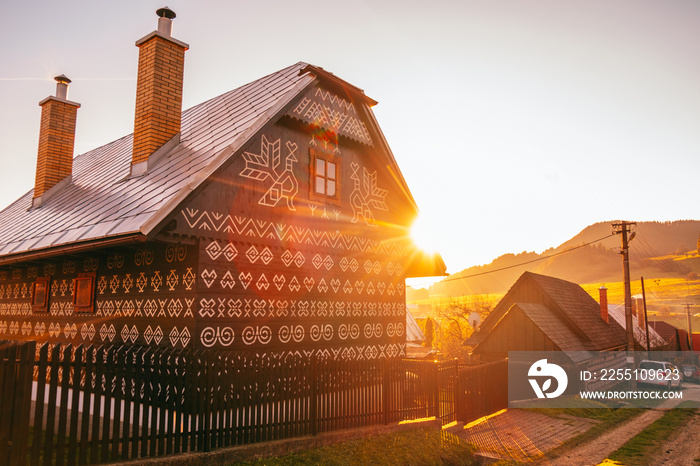 Old wooden houses in Slovakia village Cicmany in autumn. Unique decoration of log houses based on patterns used in traditional embroidery in village of Cicmany, UNESCO World Heritage Site, Slovakia