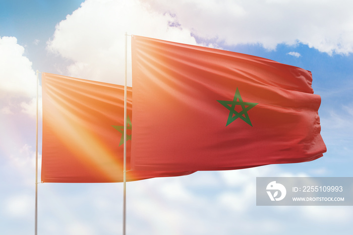 Sunny blue sky and flags of morocco and morocco