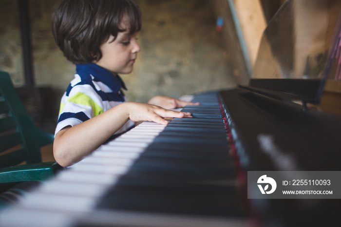 A child learns to play the piano.