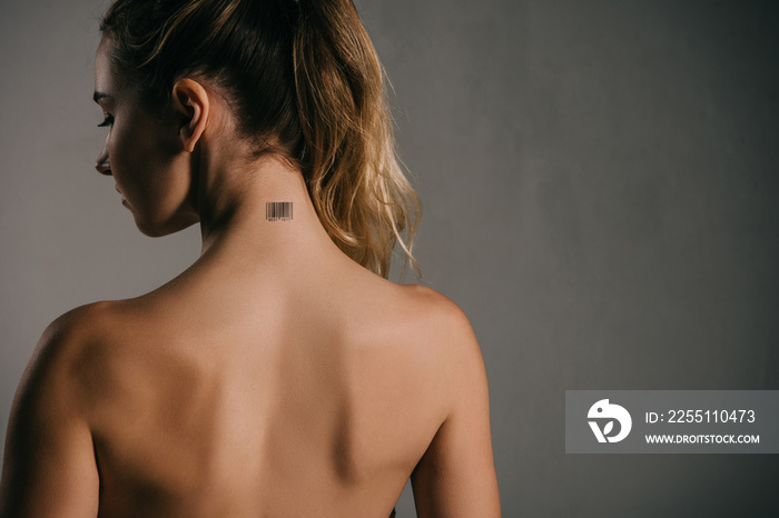 back view of woman with coded neck on grey background