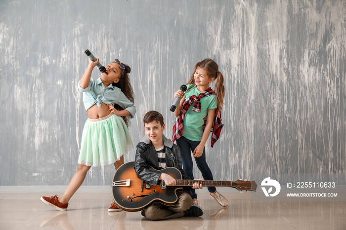 Band of little musicians against grunge wall