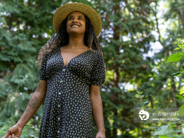 Portrait of smiling woman standing in forest