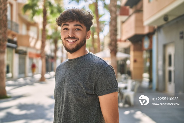 Young arab man smiling happy standing at the city.