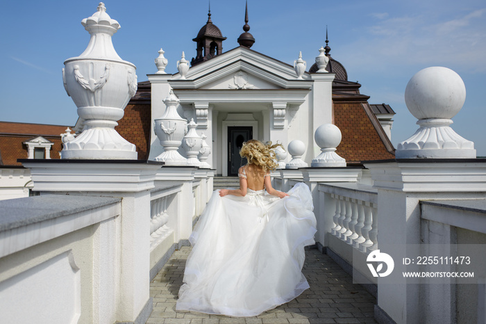 Portrait of a beautiful blonde bride. A woman runs away from her wedding.