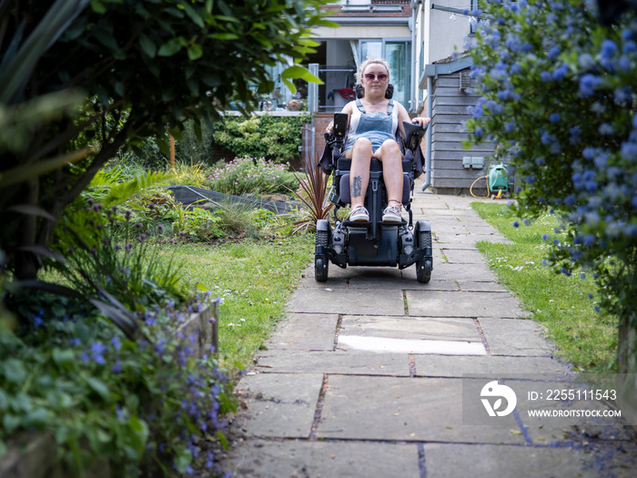 Woman in electric wheelchair outdoors