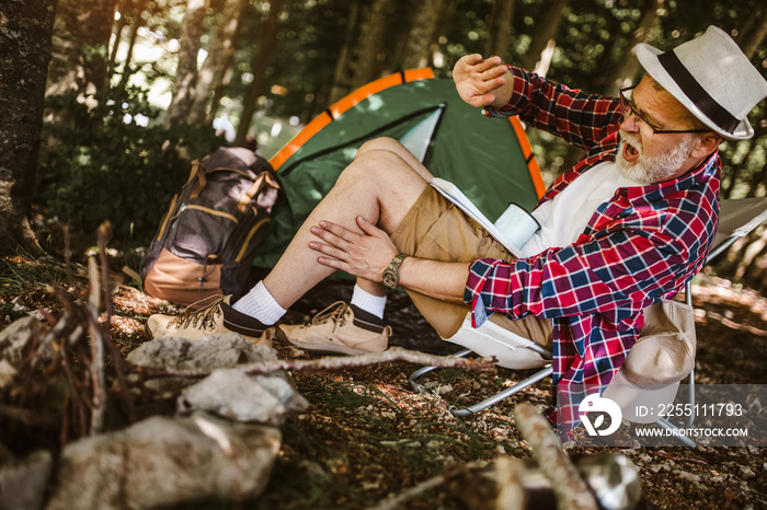 Mosquito attack mature man in forest camping