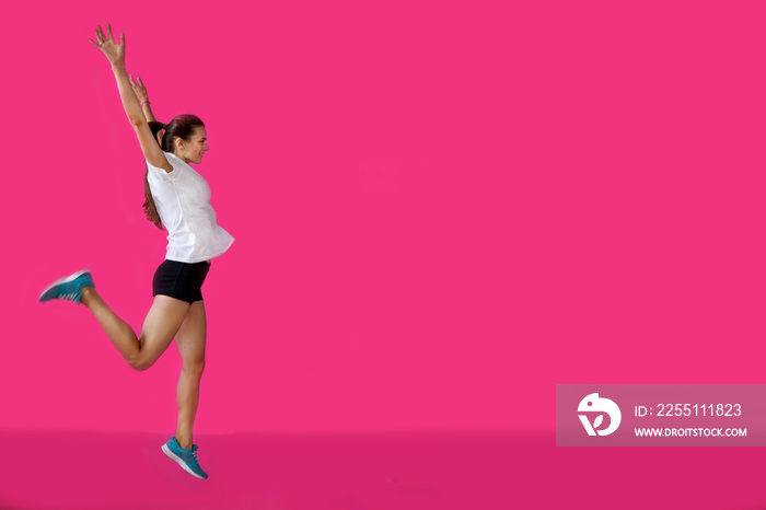 girl sportsman posing on a pink background