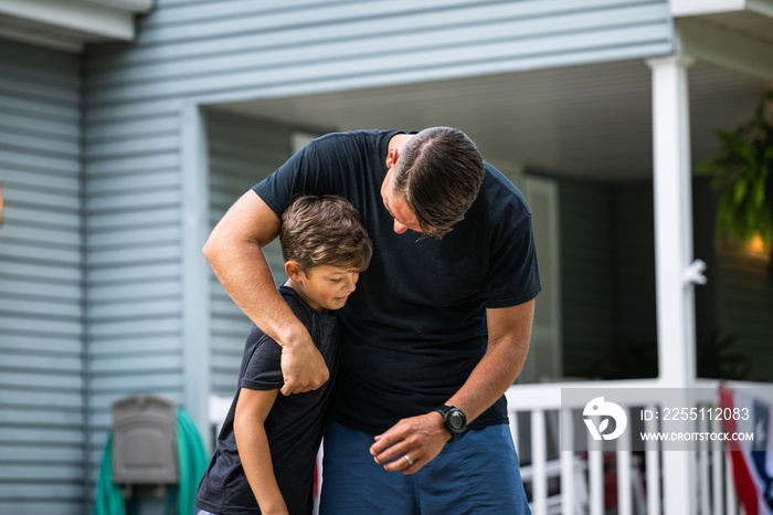 Air Force service member trains with his sons in a morning workout in preperation for a PT fitness test.