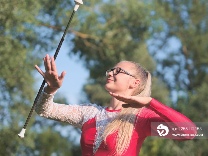 Teen Majorette Girl Twirling Baton Outdoors