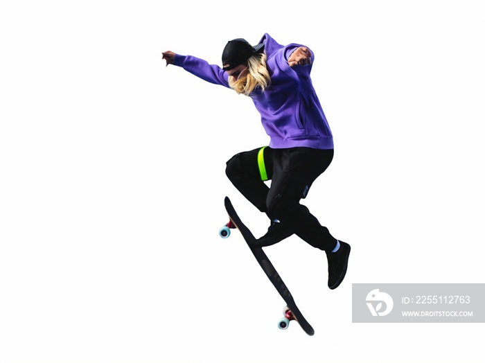 Teenager skateboarder jumps ollie on an isolated white background. The concept of street sports and urban culture