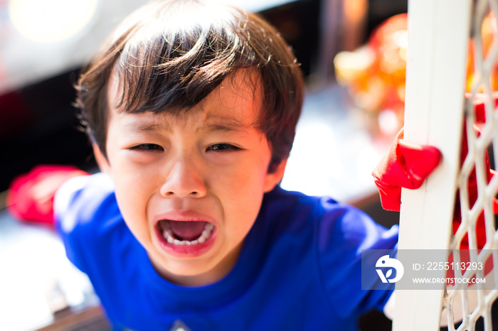 Little asian boy crying bitterly