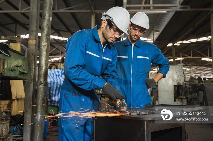 Industrial worker cutting metal and steel with many sparks