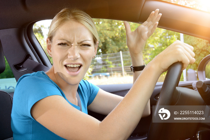 Woman as a car driver is in stress and scolds of annoyance during the car ride