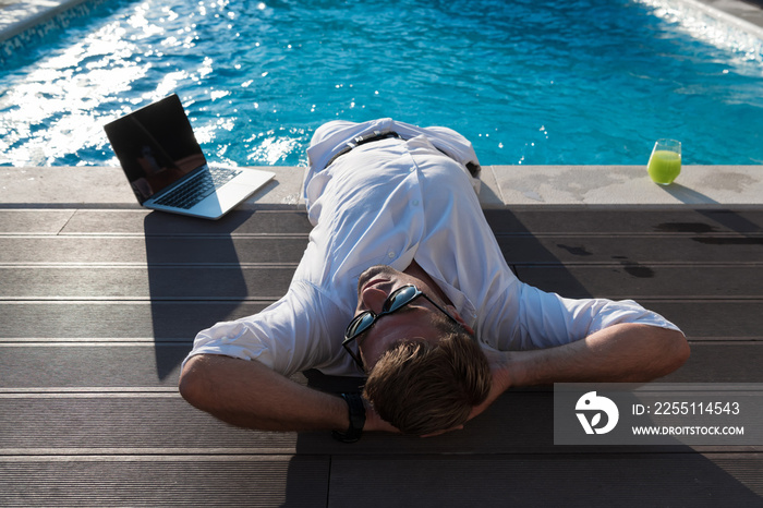 A modern senior man in casual clothes enjoys a vacation in an expensive house. Selective focus