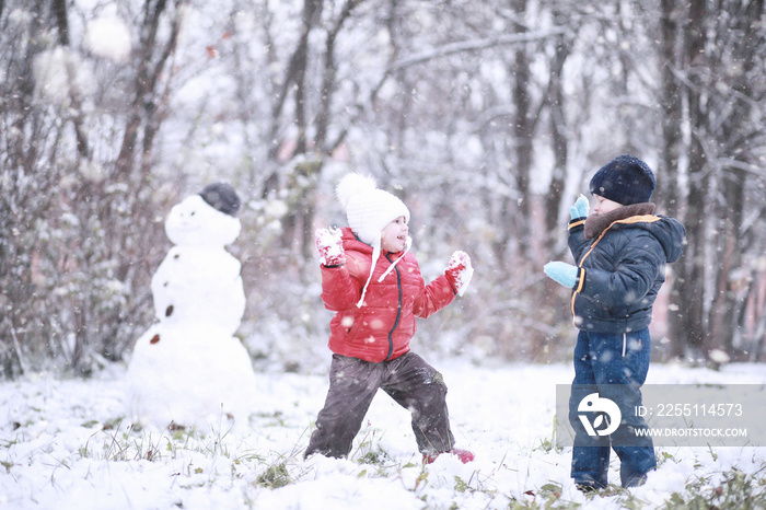 Kids walk in the park first snow