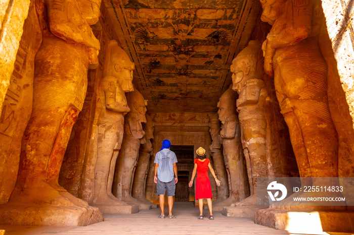 A couple at the Abu Simbel Temple next to the sculptures, in southern Egypt in Nubia next to Lake Nasser. Temple of Pharaoh Ramses II, travel lifestyle