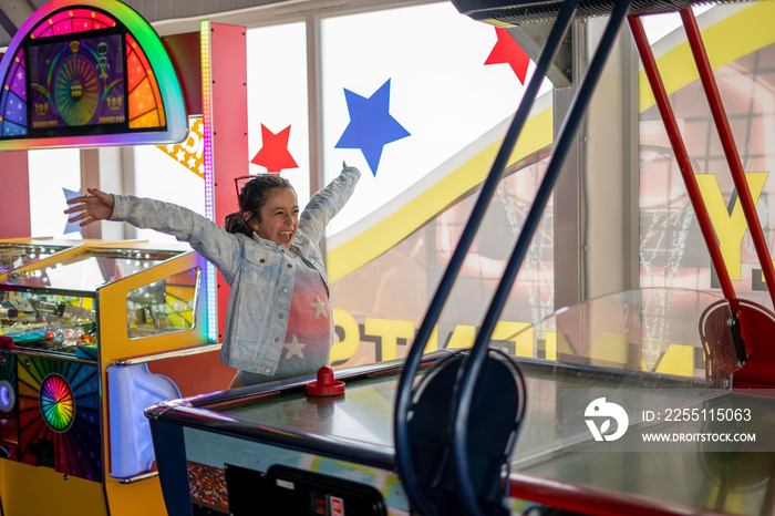 Girl (8-9) celebrating win in air hockey