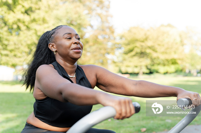 Young woman exercising in outdoor gym