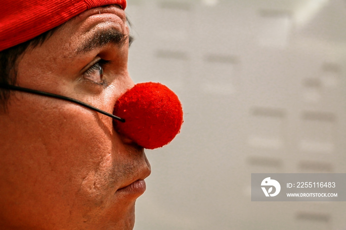 Clown look in red cap. foreground