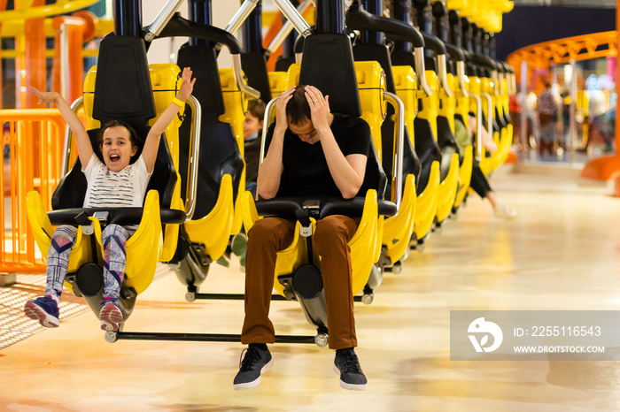 Father and Daughter On Amusement Park Roller Coaster