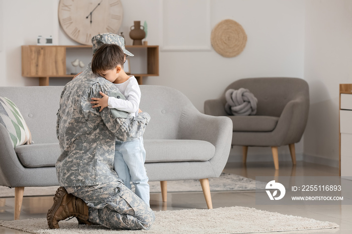 Soldier and his little son hugging at home