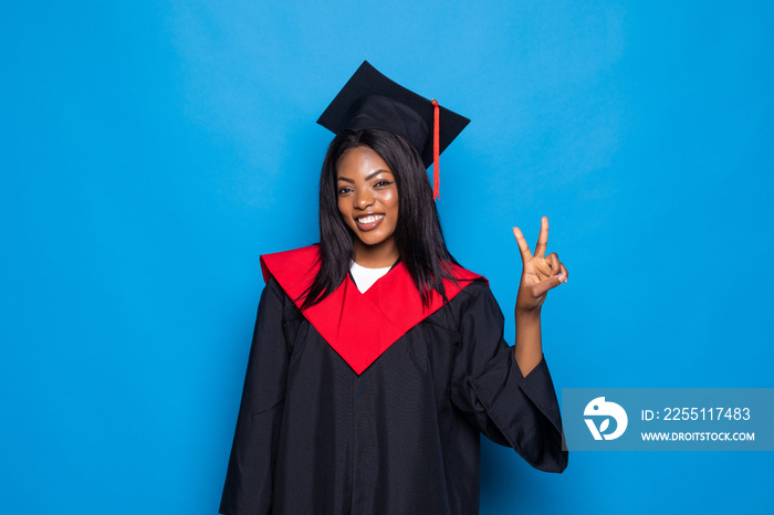 Pretty african american woman graduate isolated on blue background