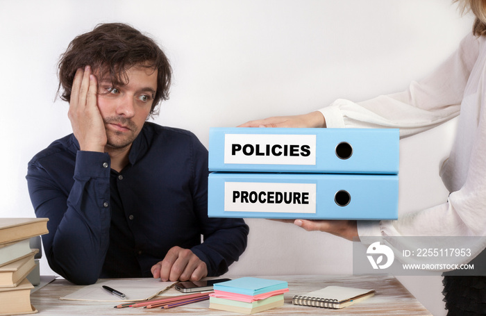 Policies and Procedure - two binders in the hands of women