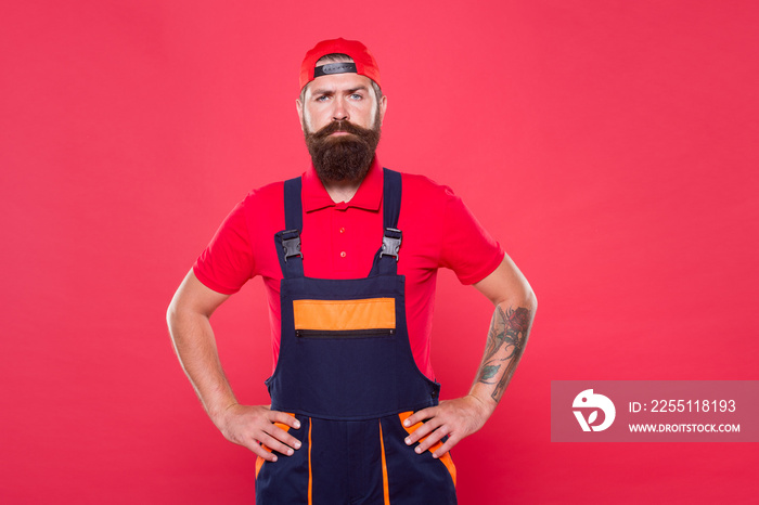 bearded worker. Hard worker red background. Construction worker or miner ready to work. brutal hipster search craftsman career. doing his job professional. First repairer job. serious builder man