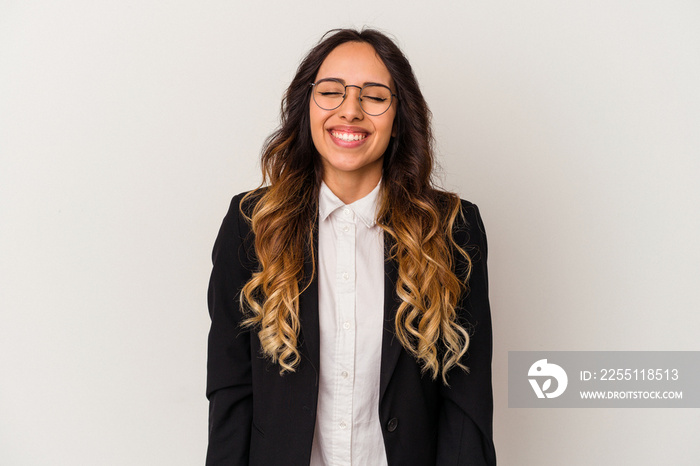 Young mexican business woman isolated on white background laughs and closes eyes, feels relaxed and happy.